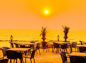Empty table and chair with sea and sunset background - Vintage Filter