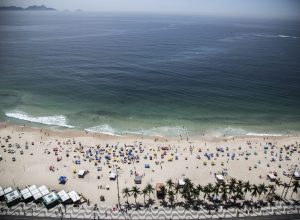 A high angle shot of Sugarloaf Mountain and a beach near the blue sea in Rio Brazil